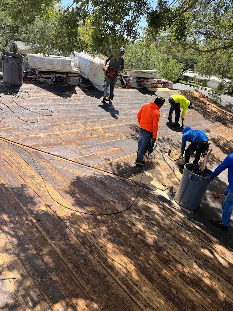 MEK Roofing crew working together during a roof replacement.