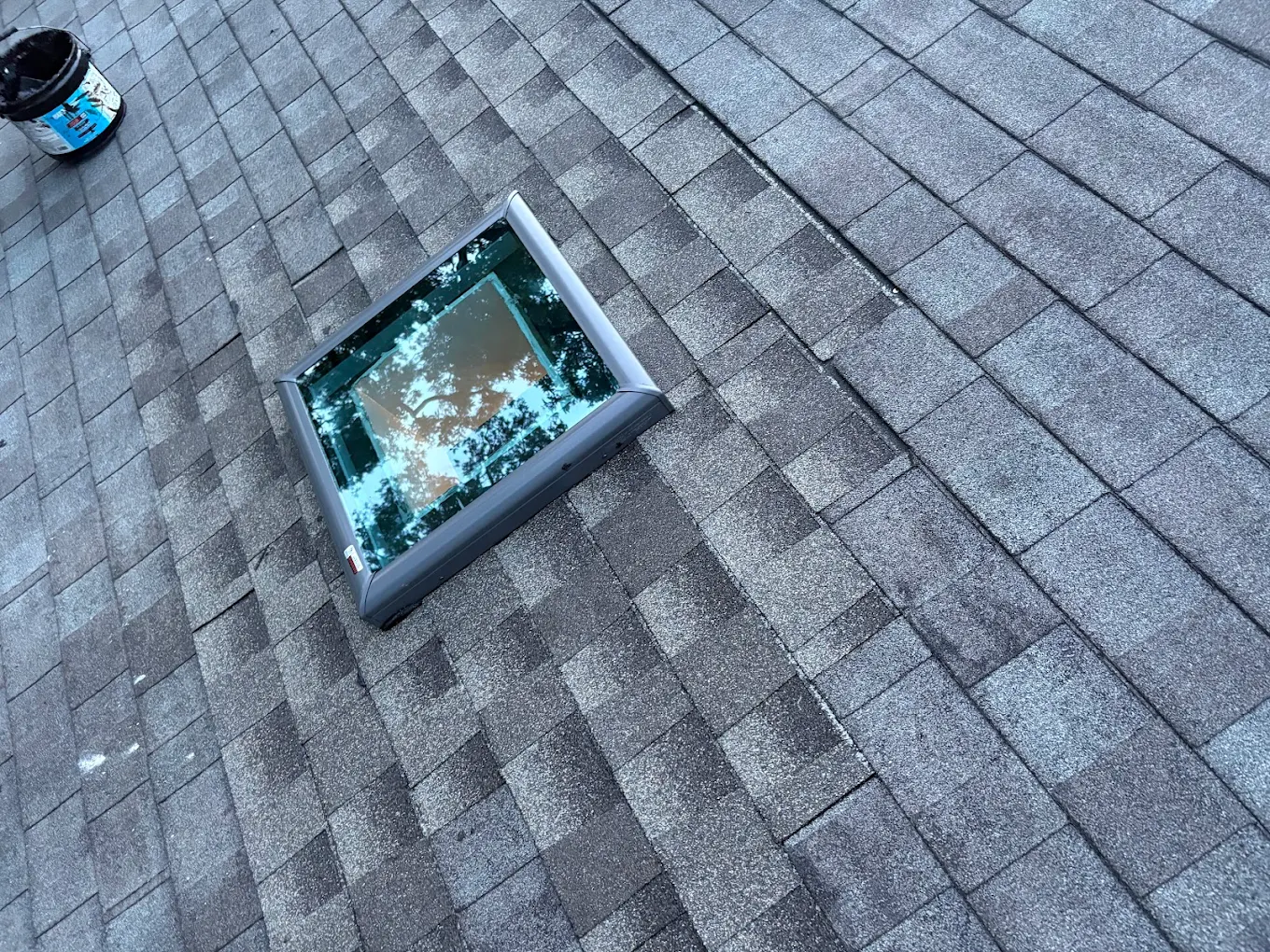 New skylight installed on a shingle roof.